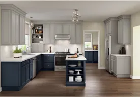 A kitchen with blue and white cabinets and a white counter top.